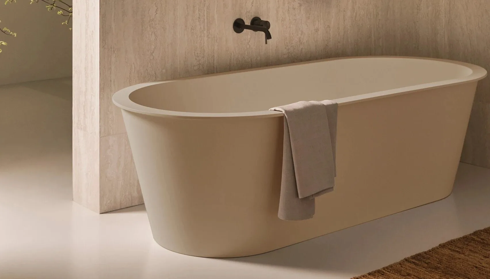 A bathroom with a freestanding bath in travertine