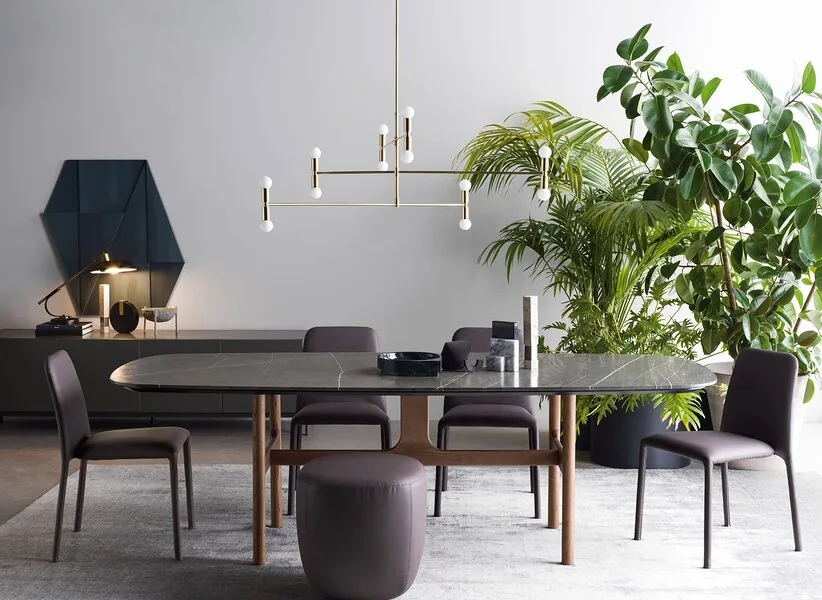 An oval table and a linear pendant