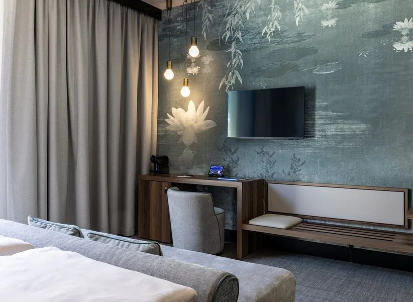 A mural behind the headboard, with pendants