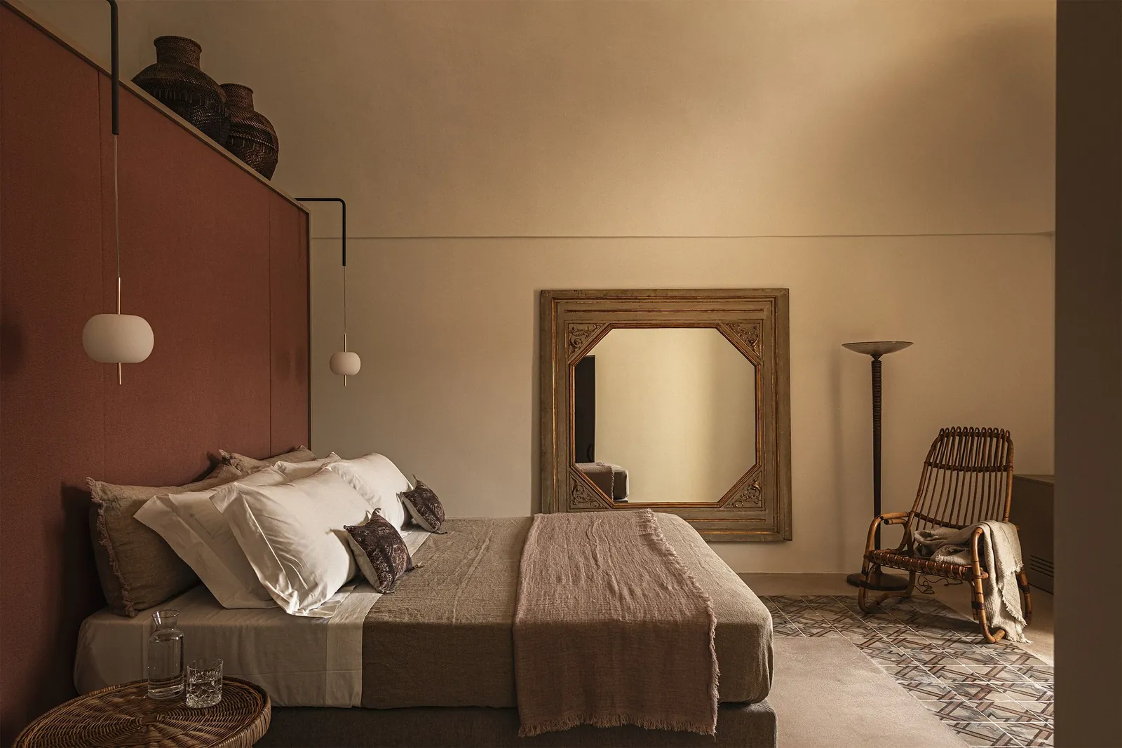 Kushi pendants by the headboard in a room at the Dimora Santagatha hotel in Noto.
